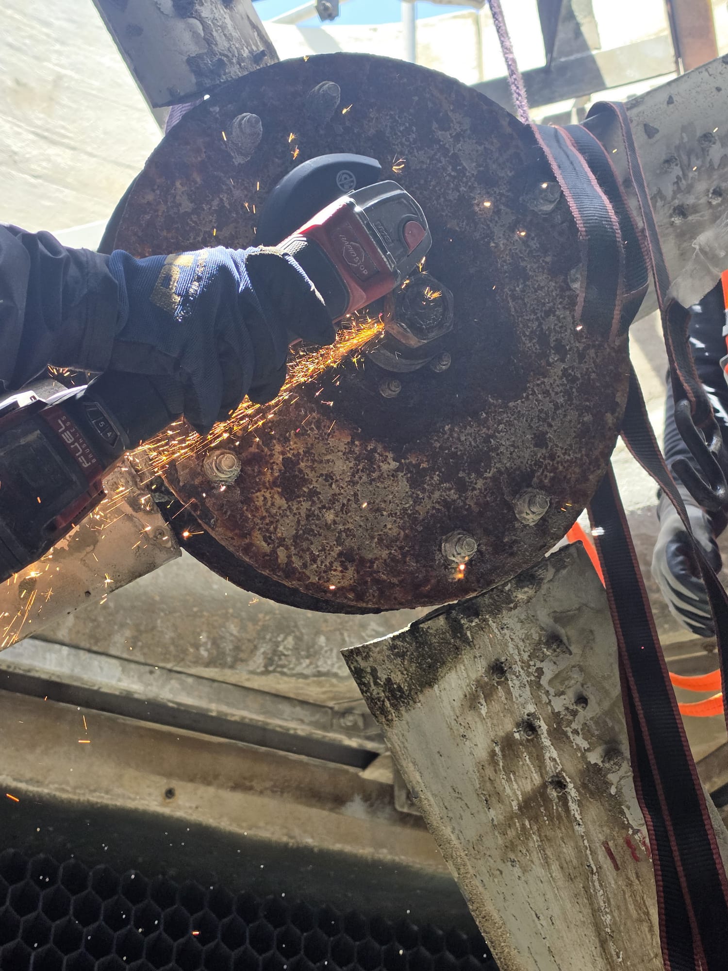 Mechanical work being performed on the cooling tower fan assembly